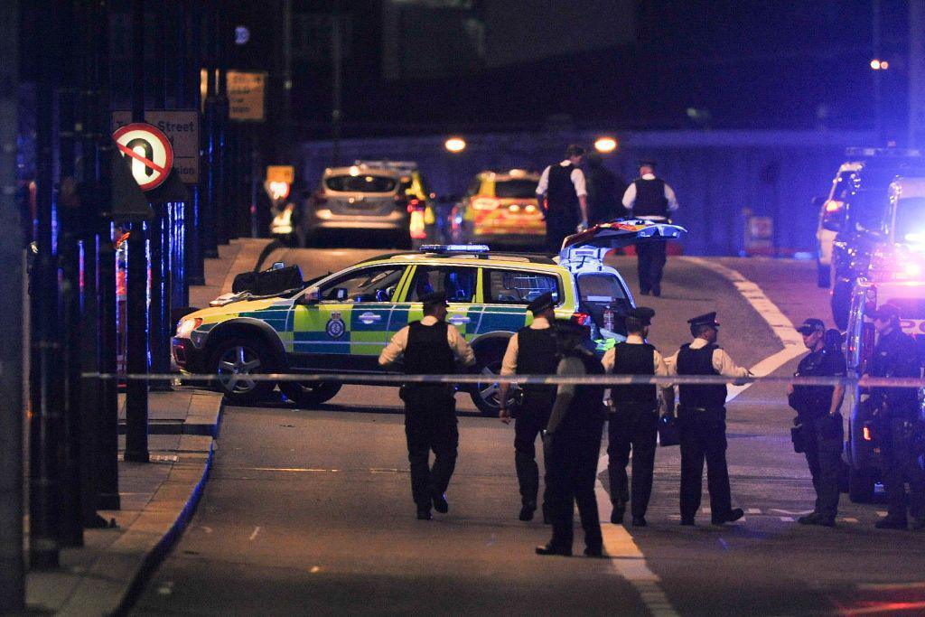 Police officers walk at the scene of a terror attack on London Bridge in central London on 3 June 3 2017