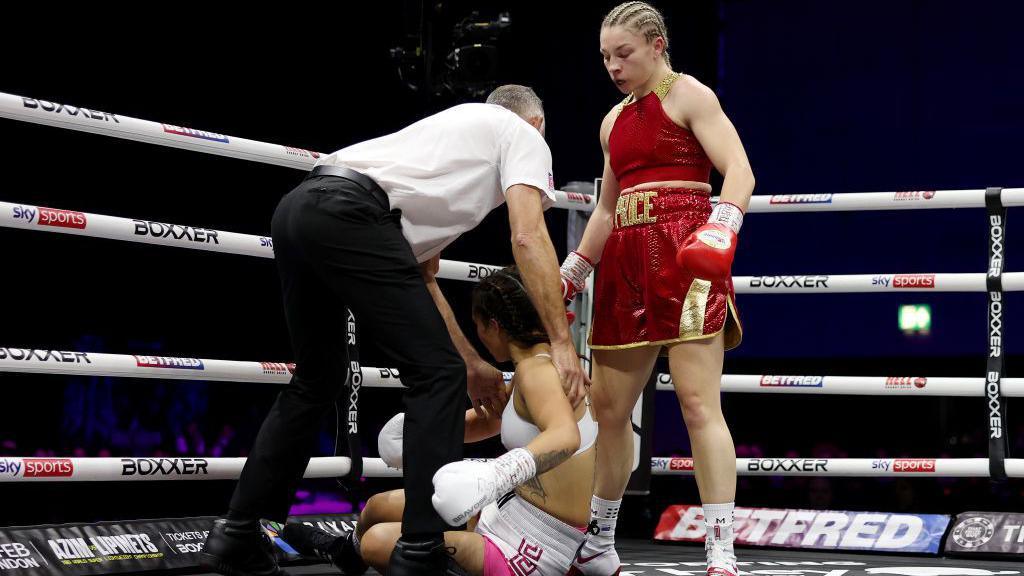 Lauren Price stands over her opponent on the floor