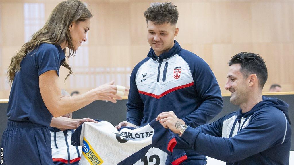 Lewis King (right) presents HRH the Princess of Wales with a rugby league shirt for her daughter Charlotte