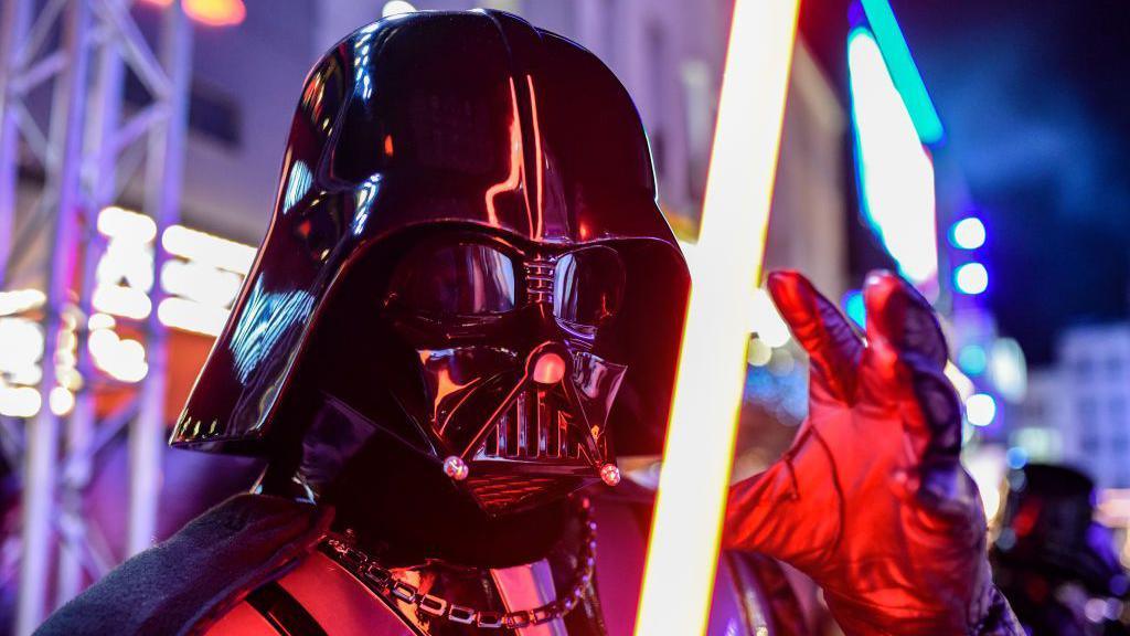 Darth Vader holding a lightsaber.