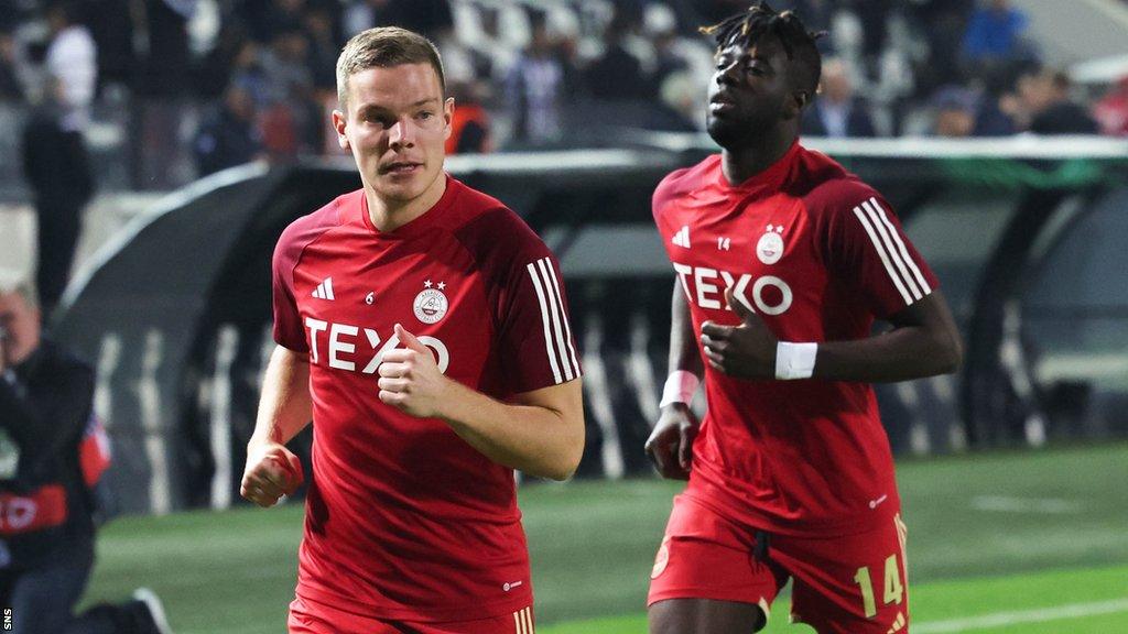 Pape Habib Gueye warms up before Aberdeen's match in Greece last week