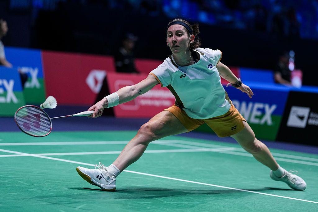 Badminton player Kirsty Gilmour stretches for a shot on the court during a match