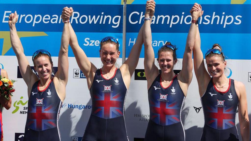 Helen Glover, Esme Booth, Samantha Redgrave and Rebecca Shorten with arms raised in victory