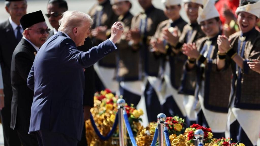 Donald Trump joins the performers in a dance during a welcoming ceremony after arriving at Kuala Lumpur International Airport, to attend the 47th Association of Southeast Asian Nations (ASEAN) Summit