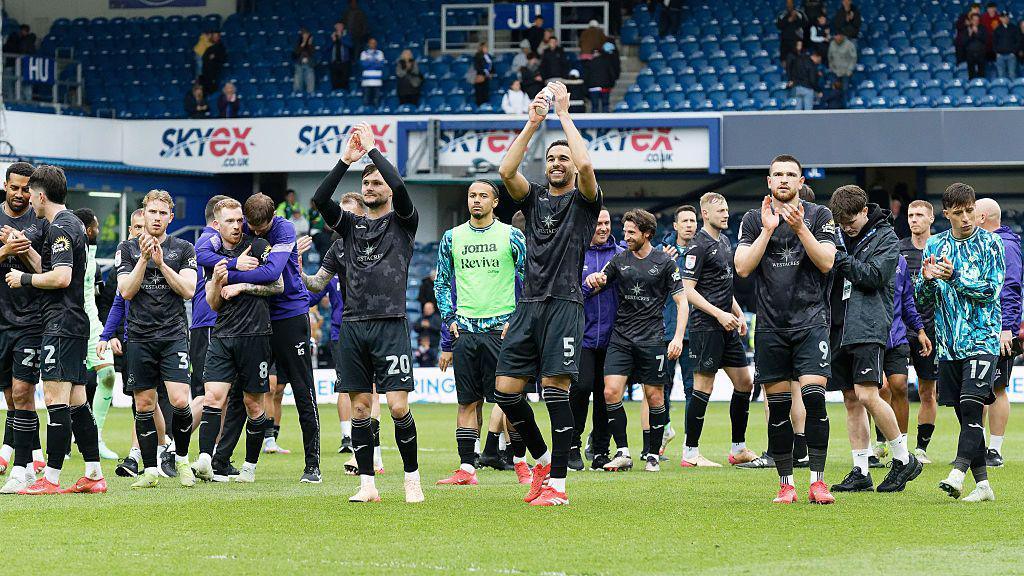 Swansea players celebrate after beating QPR