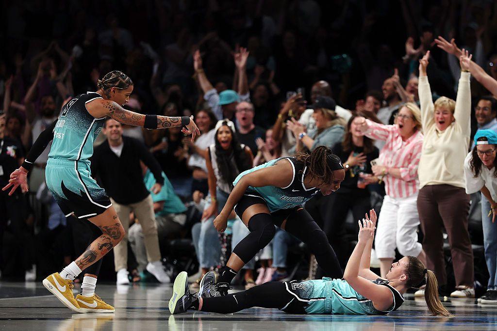 New York Liberty's Sabrina Ionescu reacts with Kennedy Burke and Natasha Cloud after scoring a three-point shot in the final minute of the game against the Minnesota Lynx at Barclays Center in the Brooklyn borough of New York City. The Liberty won 85-75. Photo by Sarah Stier