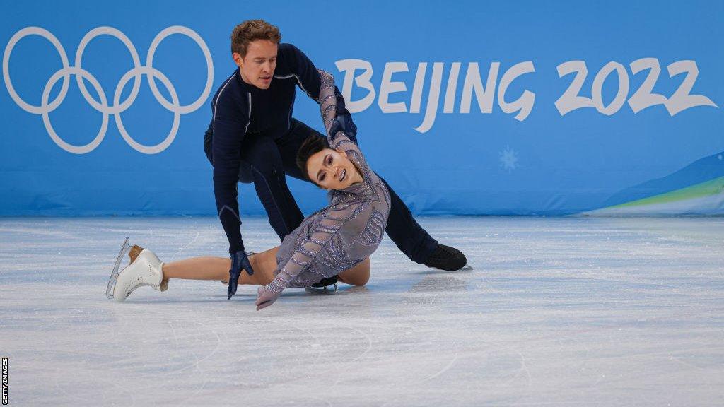 Evan Bates performs with partner Madison Chock during the ice dance free dance section of the team event at the 2022 Winter Olympics