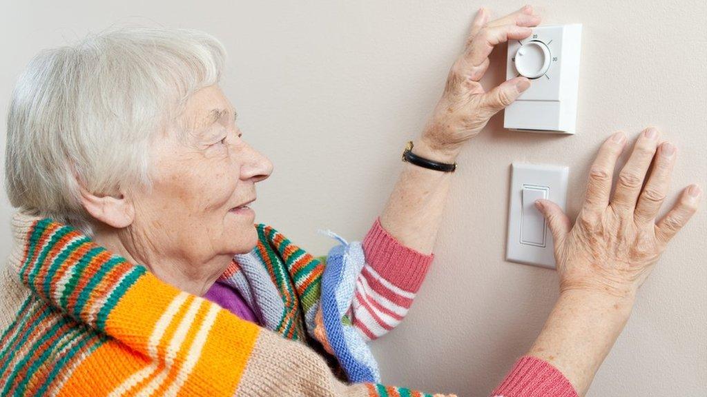 woman using thermostat