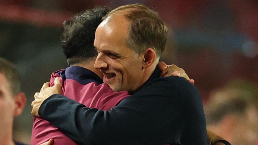 England head coach Thomas Tuchel is embraced by a member of his backroom team after the 5-0 win against Serbia in Belgrade