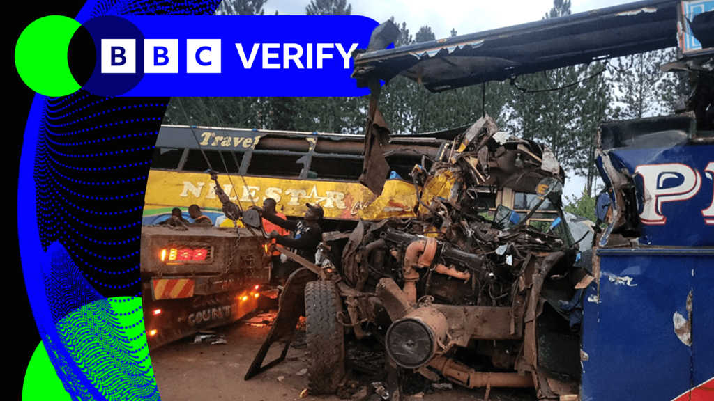 A heavily damaged bus being attached to a tow truck, with a second heavily damaged bus in the background