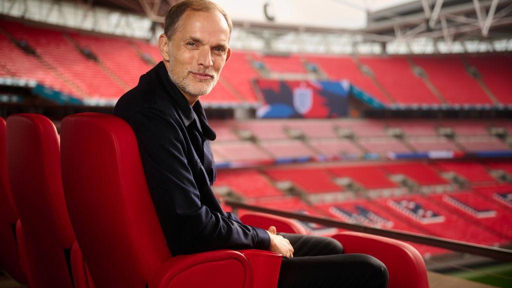 Thomas Tuchel smiles while posing for a photo at Wembley