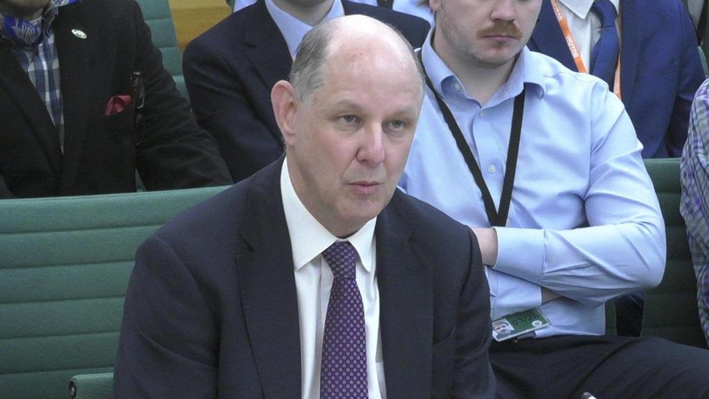 Philip Barton giving evidence to MPs. He is wearing a suit and purple tie