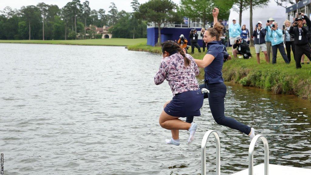 Lilia Vu jumps into water with a friend after winning the Chevron Championship