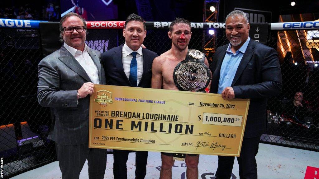 Brandan Loughnane with his belt and winner's cheque