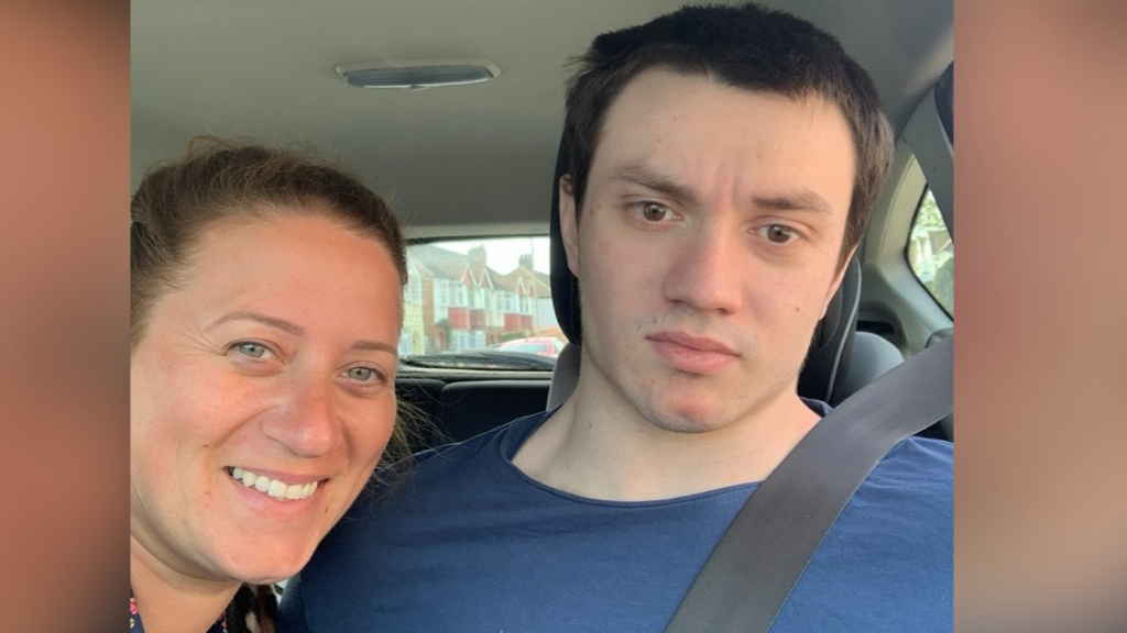 Jack (on the right) in a car with his seatbelt on and in a blue top. Sophie (on the left) smiling and looking into the camera