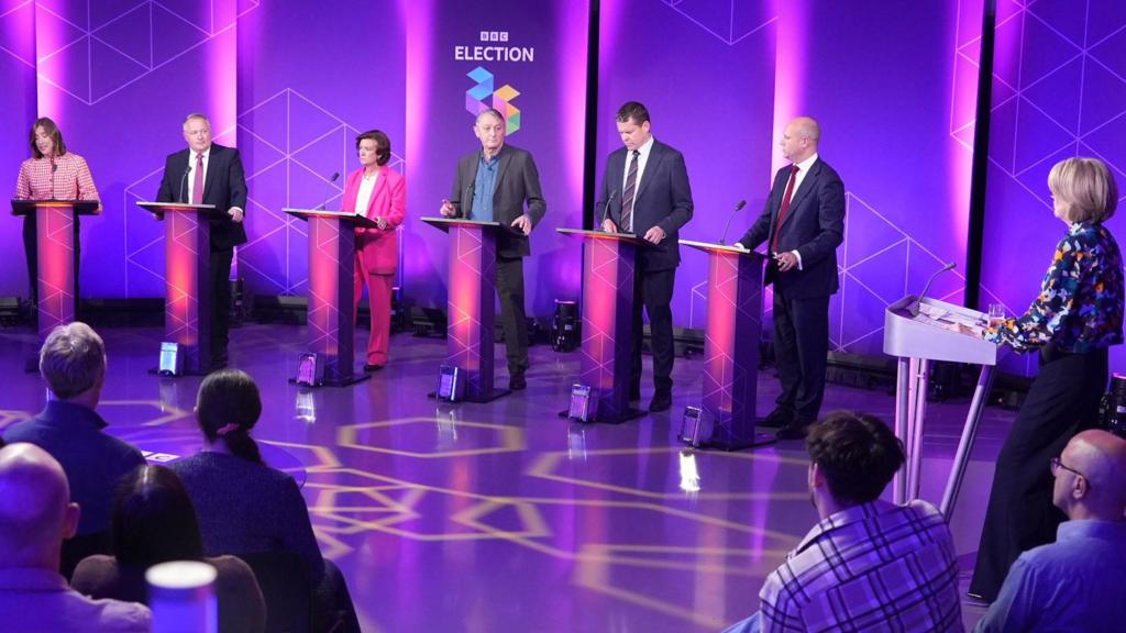 Politicians stood in front of podiums