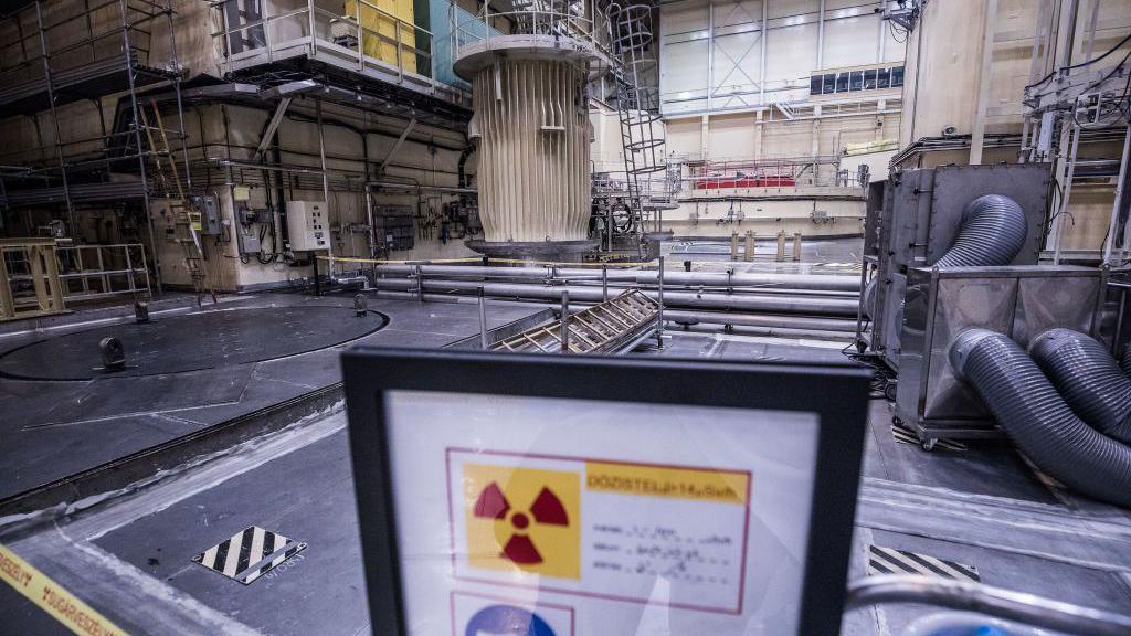 A warning sign stands inside the reactor room at the Paks nuclear power plant