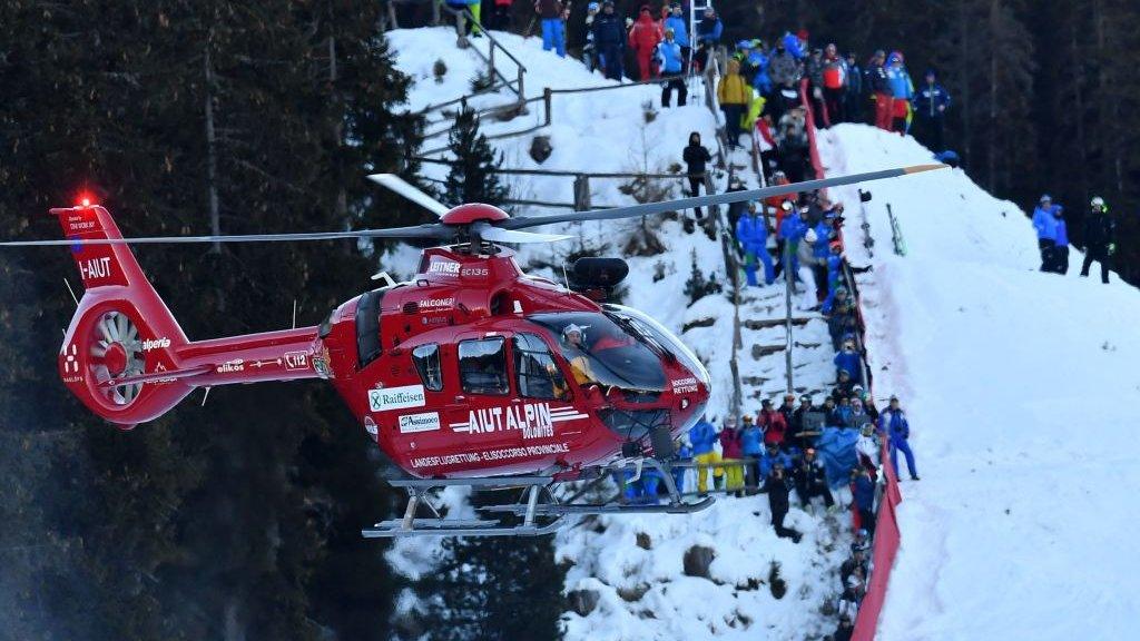 A helicopter airlifting Marc Gisin from the slopes at Val Gardena