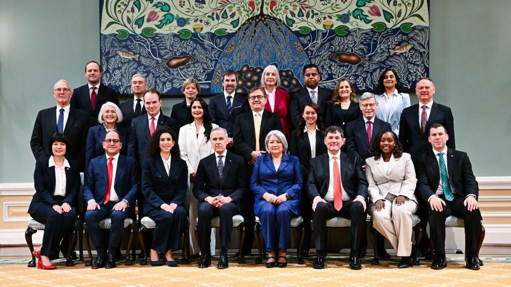 Carney, pictured in the centre, with his new cabinet ministers