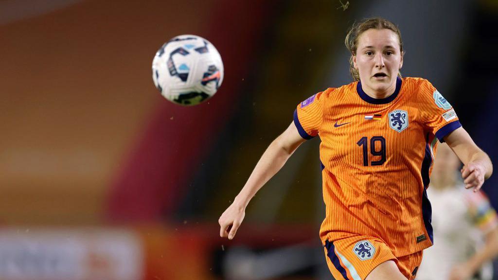 Wieke Kaptein chases a bouncing ball while playing for the Netherlands