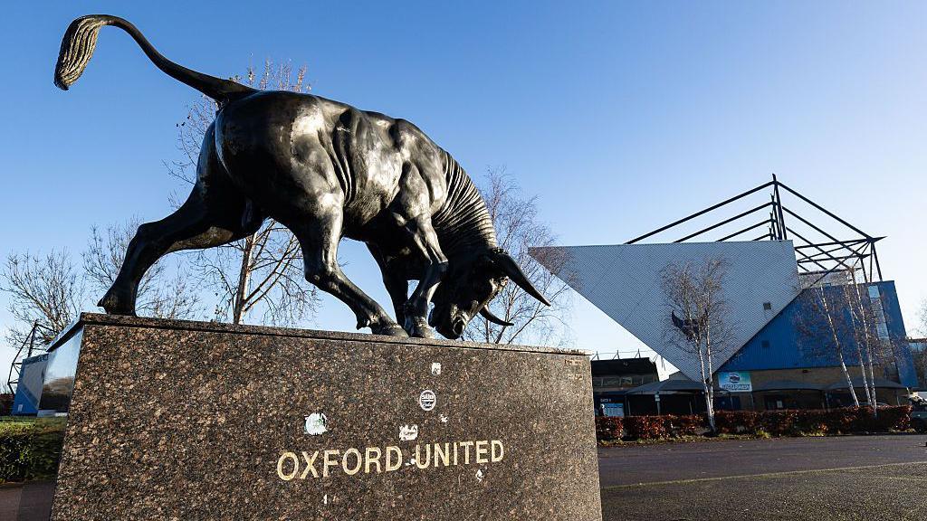 A general view of the outside of Oxford United's Kassam Stadium with a statue of an Ox in the foreground