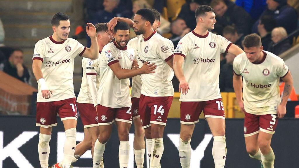 Nahki Wells (second from left) celebrates with his team-mates after scoring