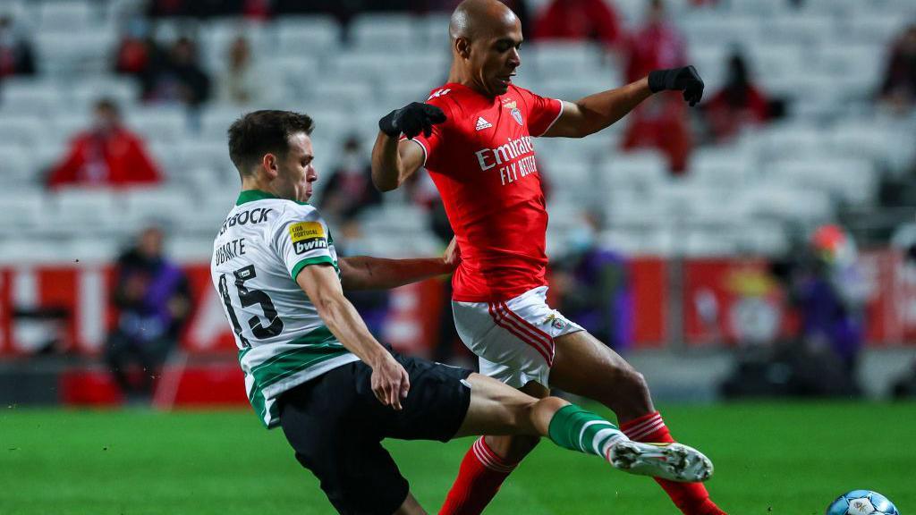 Ugarte challenges Joao Mario for the ball in a Portuguese Primeira Liga match between Sporting and Benfica