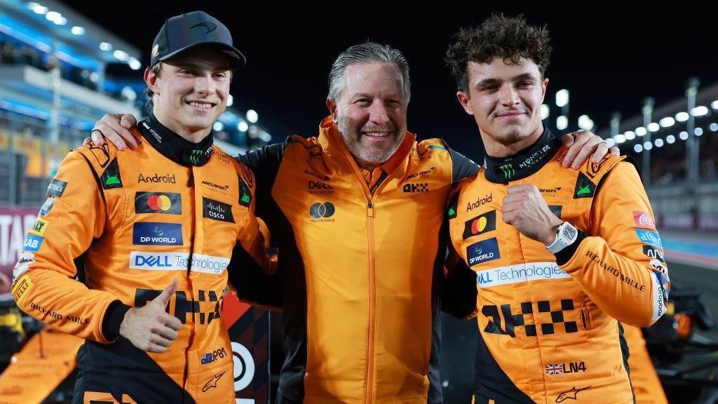 Oscar Piastri, Zak Brown and Lando Norris pose for photographs 