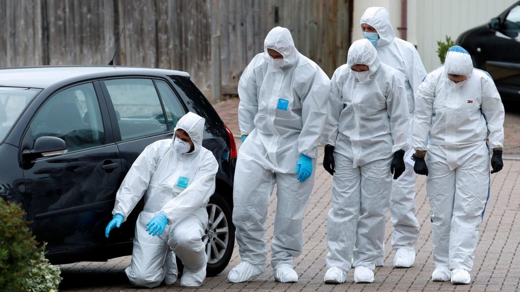 Search team police officers are seen following a shooting in Kesgrave, near Ipswich