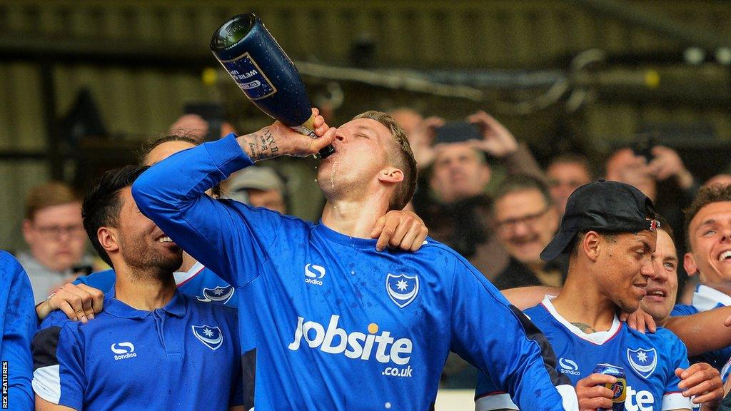 Pompey players celebrate after securing promotion to League One.