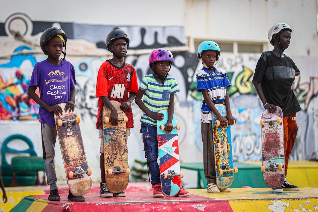 Senegalese skateboarders stand with their boards at the country's first skate park, which is is filled with young people and children almost every day of the week.