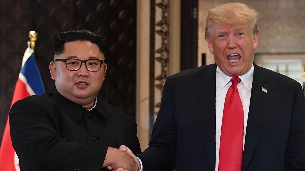 Kim Jong-Un and President Trump shake hands