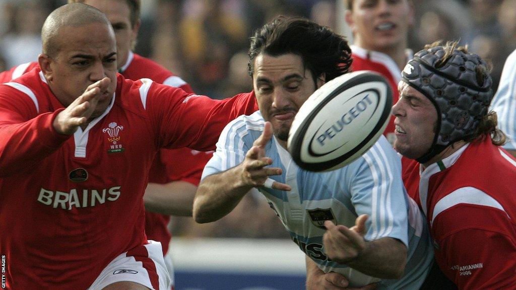 Argentina's Agustin Pichot is tackled by Wales' Gavin Thomas and Alun Wyn Jones in 2006