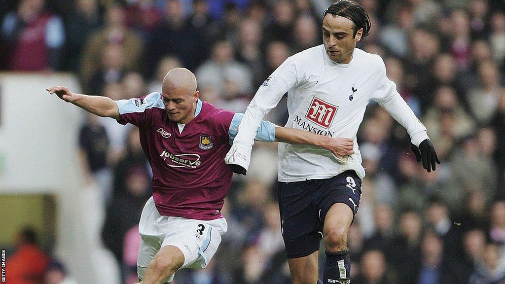 Paul Konchesky playing for West Ham against Tottenham's Dimitar Berbatov