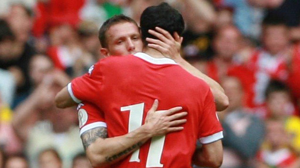 Wales captains Craig Bellamy and Ryan Giggs hug