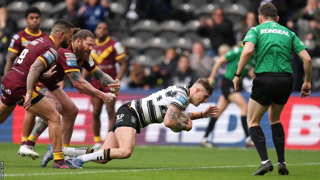 Hull FC's Liam Sutcliffe dives over for a try against Huddersfield