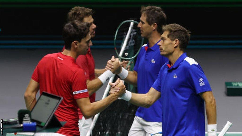 Nicolas Mahut and Edouard Roger-Vasselin of France shake hands with Swiss pair Marc-Andrea Huesler and Stan Wawrinka.