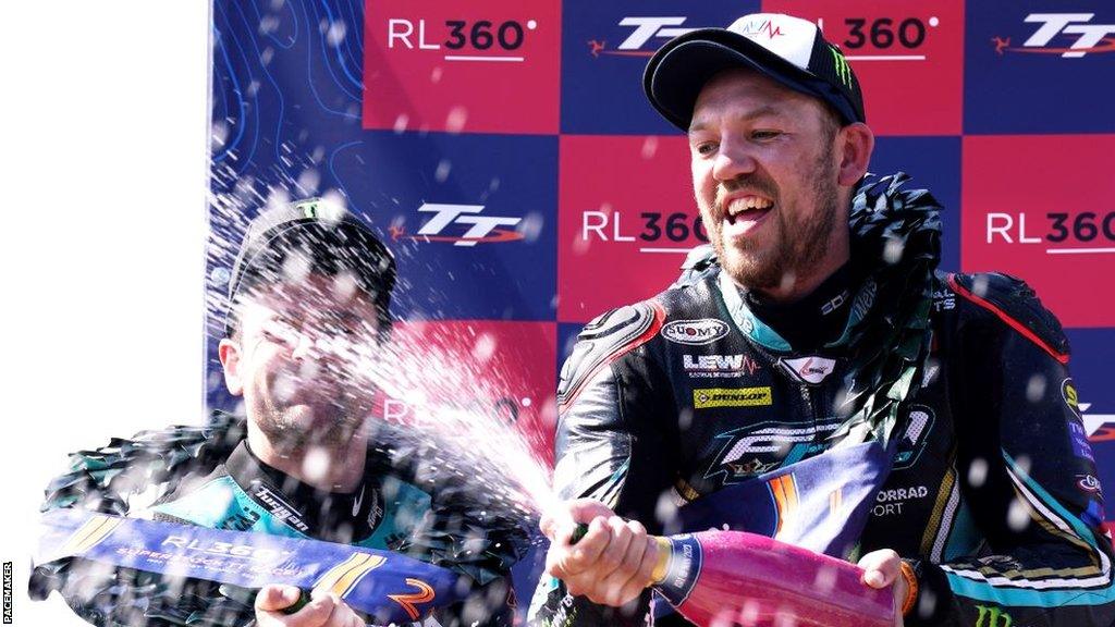 Peter Hickman sprays champagne on the podium