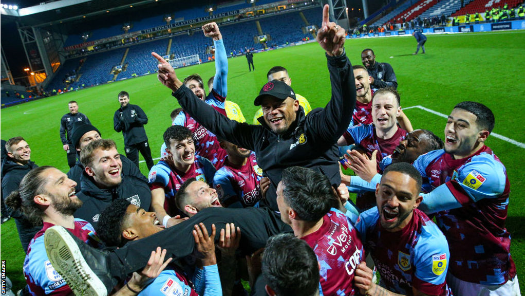 Vincent Kompany is thrown into the air in celebration by his Burnley players after winning the Championship title