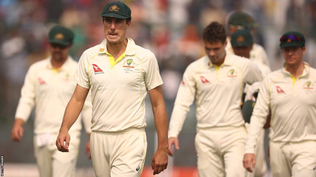 Australia captain Pat Cummins leads his side from the field after defeat by India