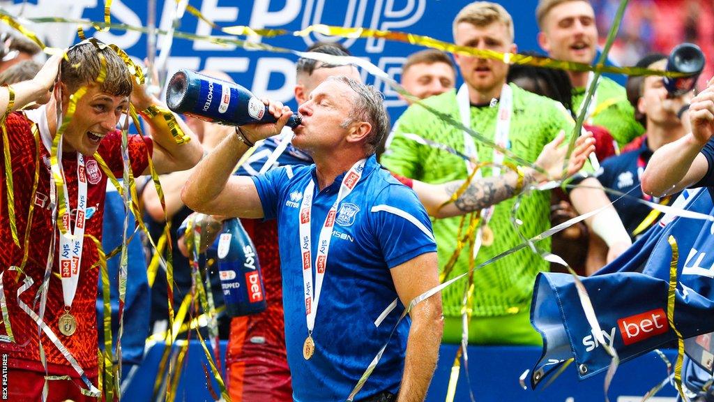 Paul Simpson drinks champagne