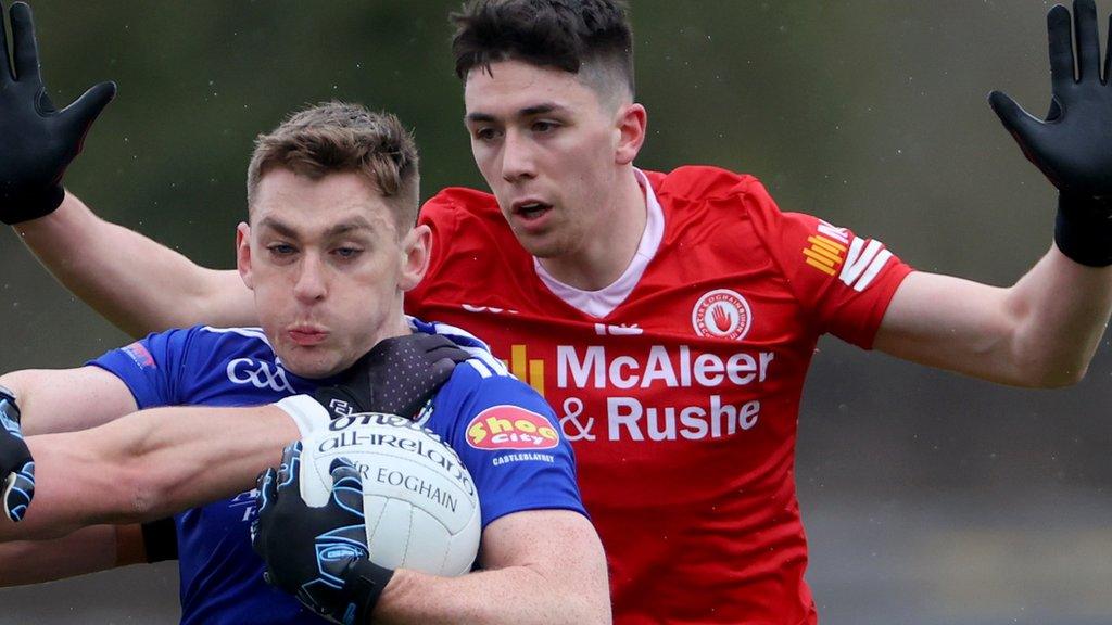 Monaghan forward Micheal Bannigan holds off the challenge of Tyrone's Joe Oguz