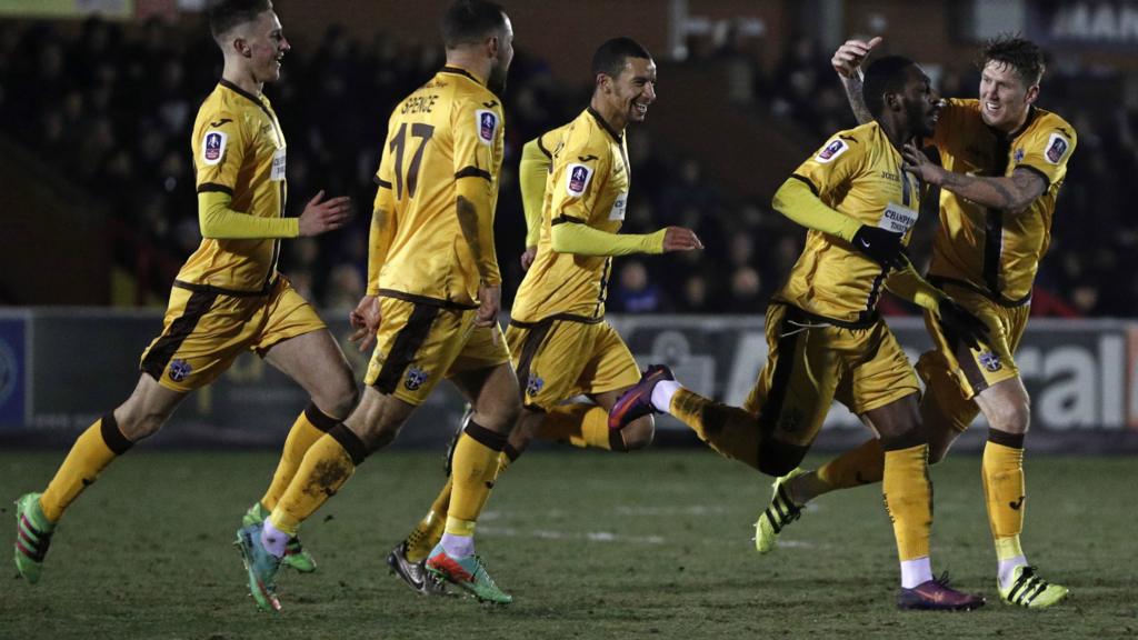 Sutton celebrate scoring their equaliser against Wimbledon