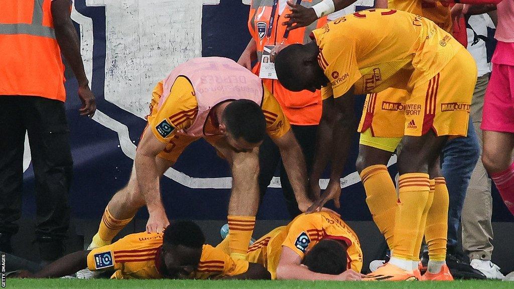 Rodez midfielder Lucas Buades lies on the pitch after being shoved to the ground against Bordeaux