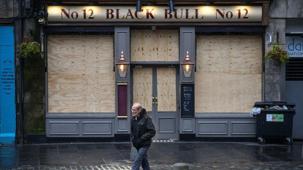 Boarded up pub in lockdown