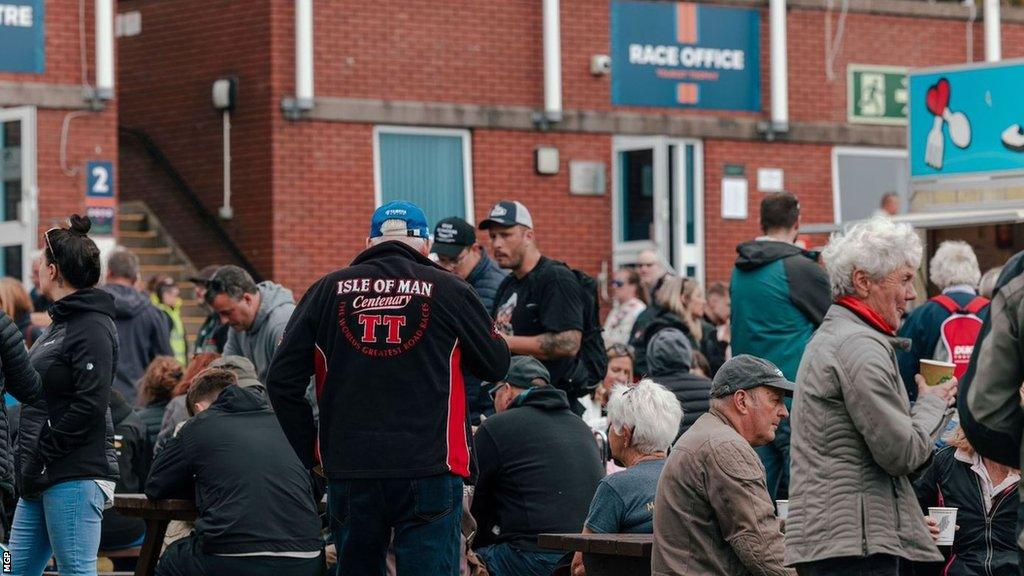 Race fans at the back of the grandstand