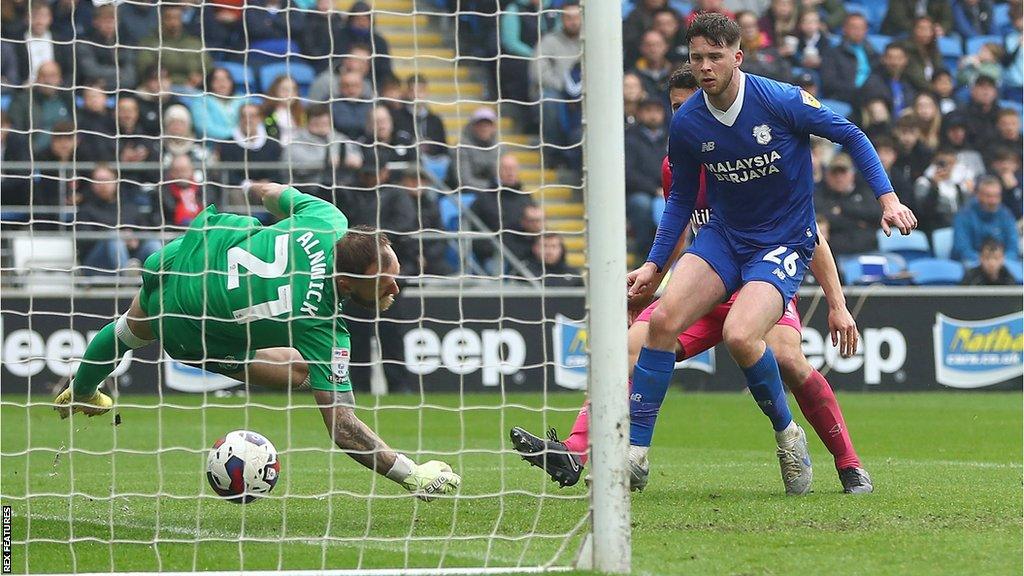 Cardiff's Jack Simpson scores an own goal against Huddersfield