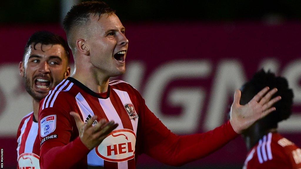 James Scott celebrates scoring the winner for Exeter