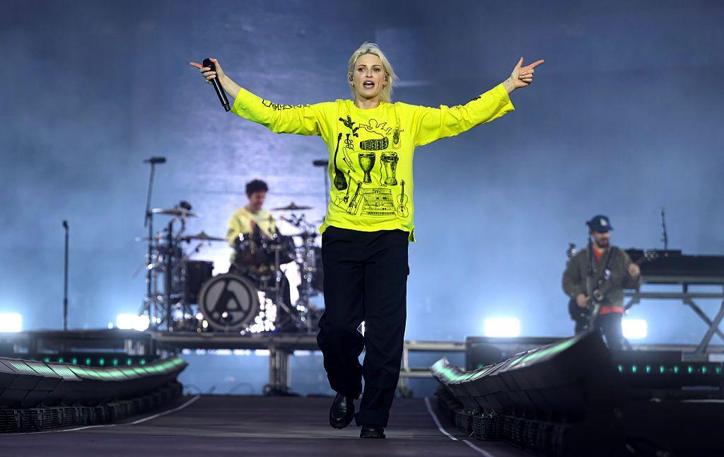 Emily Armstrong of Linkin Park, dressed in bright green, performs onstage during Download Festival 2026 at Donington Park.
