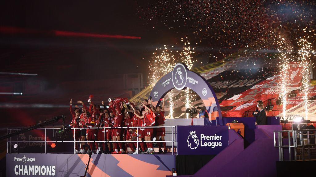 Jordan Henderson lifts the Premier League trophy in 2020